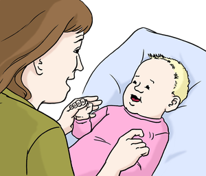 Eine Frau hält die Hand von einem Baby.
Die Frau kitzelt das Baby.
Das Baby liegt auf einem Kissen.